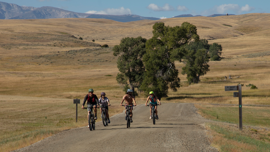 A group of cyclists pedal the ranch road near the main Cottonwood Campus of Tippet Rise.  Photo by Kevin Kinzley.