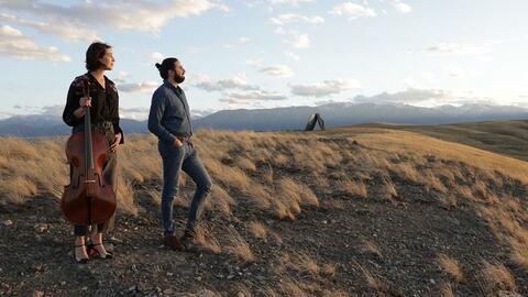 Camille Thomas & Julien Brocal stare off into the distance at the vast landscape of Tippet Rise.