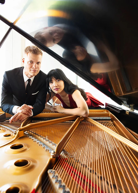 Greg Anderson and Elizabeth Joy Roe look through the open lid of a Steinway grand piano.