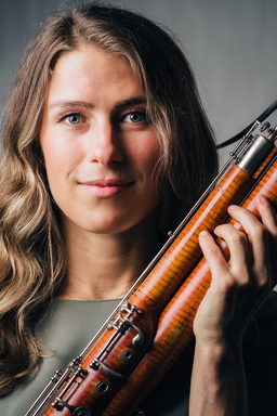 Eleni Katz holds her bassoon as her hair flows down
