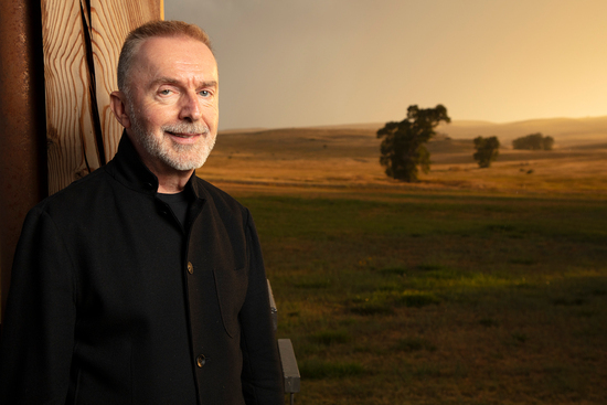 Pedja Mužijević smiles in the sunset on the veranda of the Olivier Music Barn at Tippet Rise.
