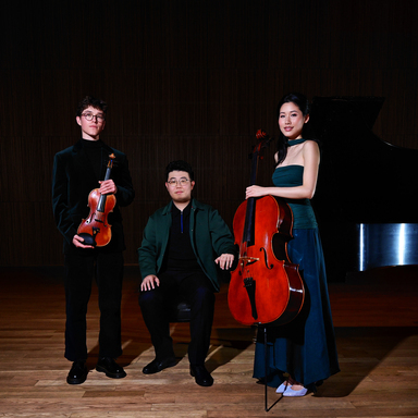 Trio Azura stand in a group holding their instruments.